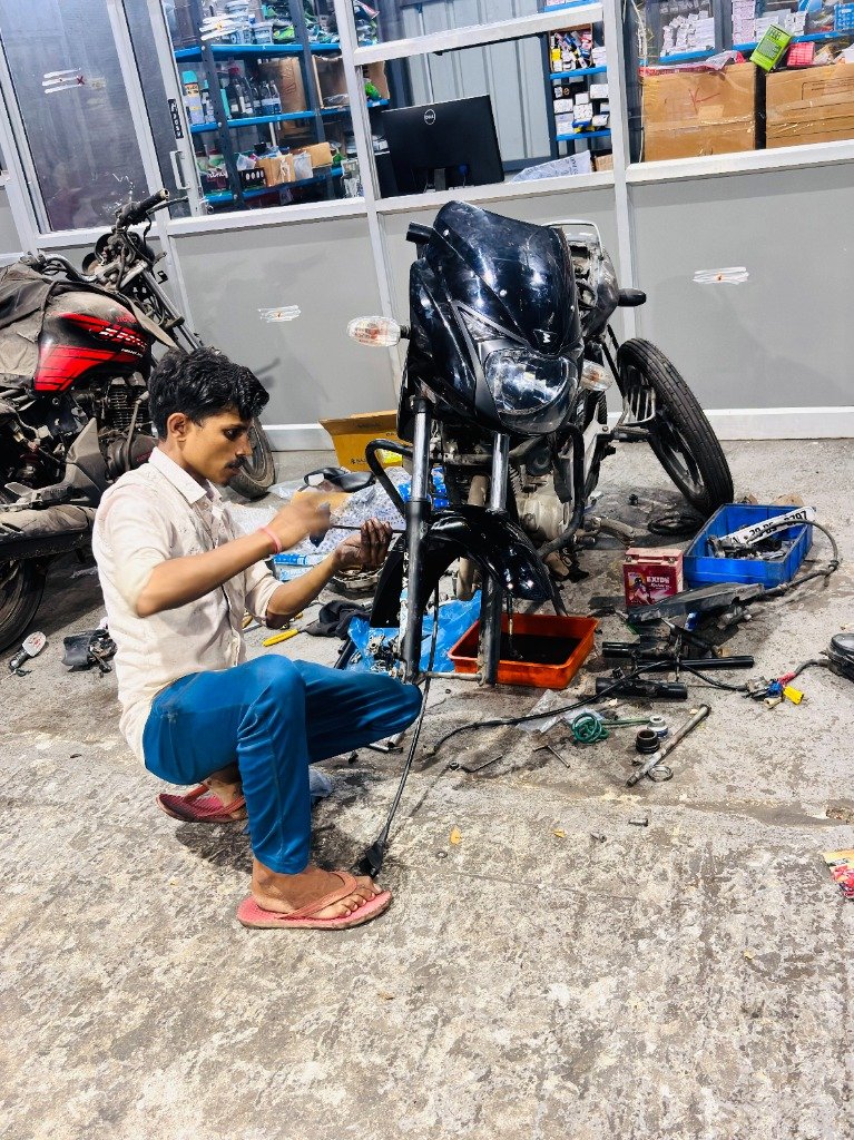 Technician rebuilding front fork and wheel assembly