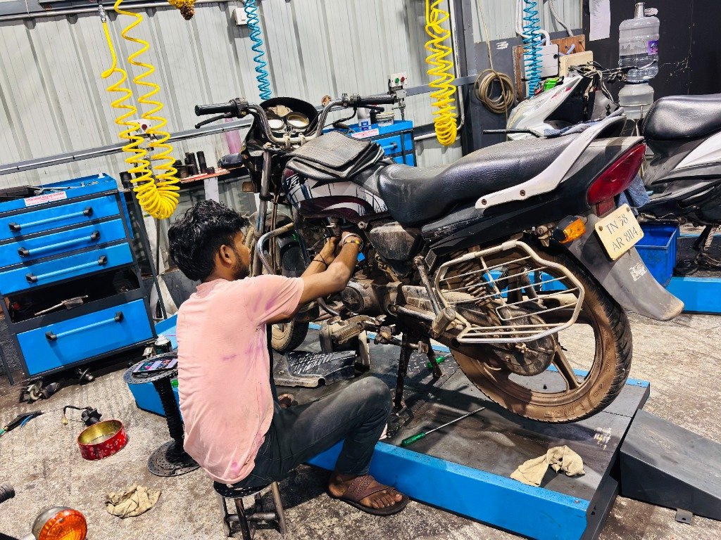 Motorcycle inspection on hydraulic lift bay